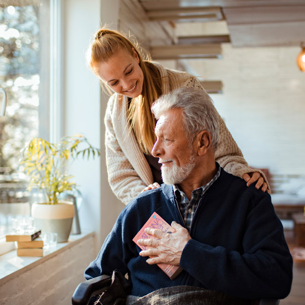 caregiver helping man in wheelchair