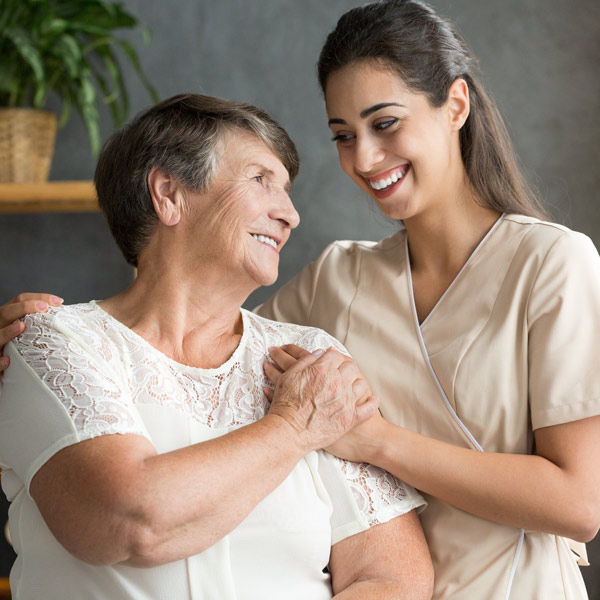 female nurse helping female patient